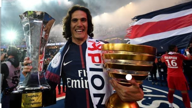 Cavani lifting the Coupe de France and Coupe de la Ligue trophies