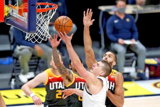 Nikola Jokic from the Nuggets, goes to the basket against the Utah Jazz