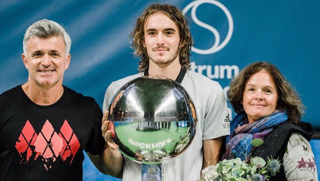 Stefanos Tsitsipas poses with his silverware along side his parents.