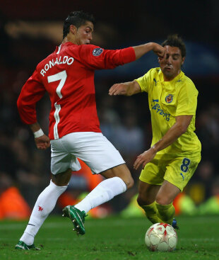 Ronaldo tries to dribble past Santi Cazorla